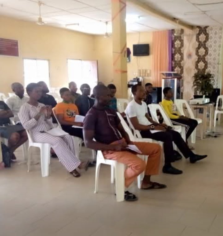 Participants seated in a hall during a capacity building and training session