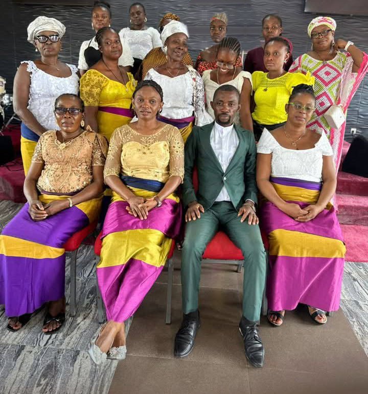 Group photo of women participants seated and standing with a facilitator